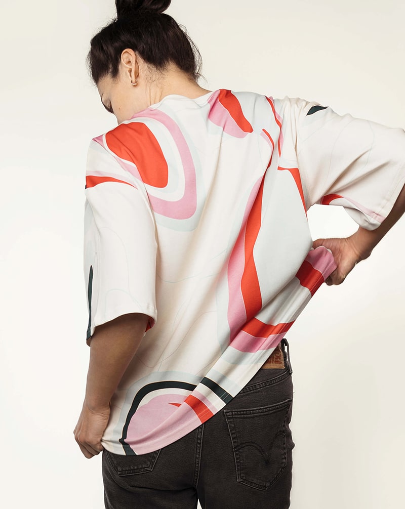 Back view of a woman in a colorful nursing t-shirt, showcasing comfortable nursing fashion.