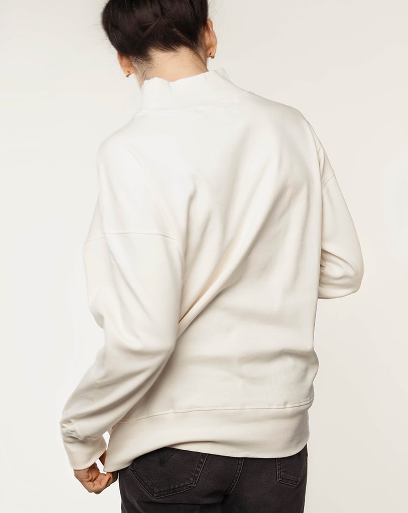 Back view of a white nursing jumper, highlighting its relaxed fit and smart design.