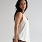 Side view of a white nursing top showing relaxed fit and easy breastfeeding access.