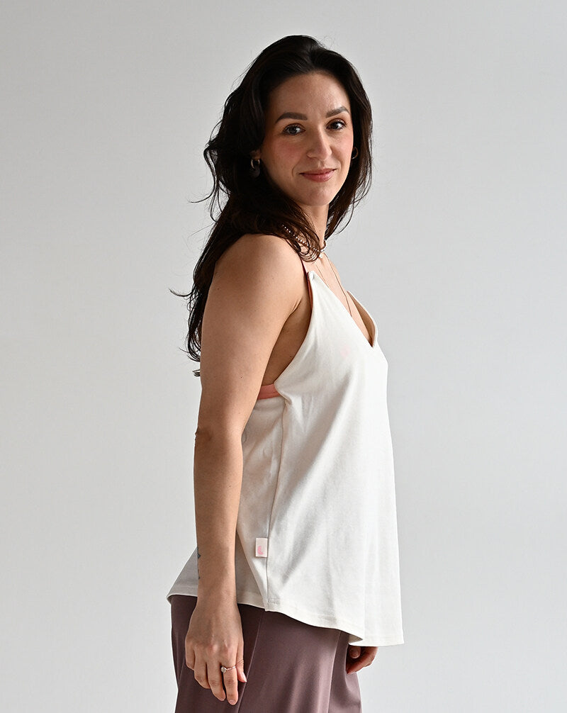 Side view of a white nursing top showing relaxed fit and easy breastfeeding access.