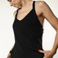 A woman wearing a loose black nursing top with an inner nursing bra, ideal for nighttime feedings.
