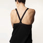 Back view of a black nursing top, highlighting its relaxed fit and wide, cross-back straps.
