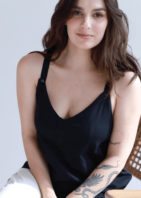 Close-up of a woman wearing a black nursing top with a deep V-neckline. Stylish and modern breastfeeding clothes designed for nursing moms.