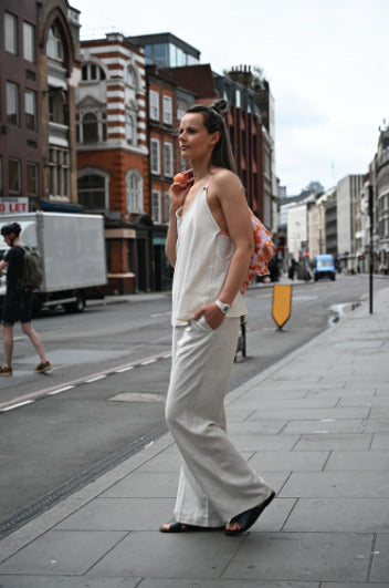 Young mother showcasing a modern nursing top while walking on the streets of London. Stylish and comfortable breastfeeding clothes for nursing moms on the go.