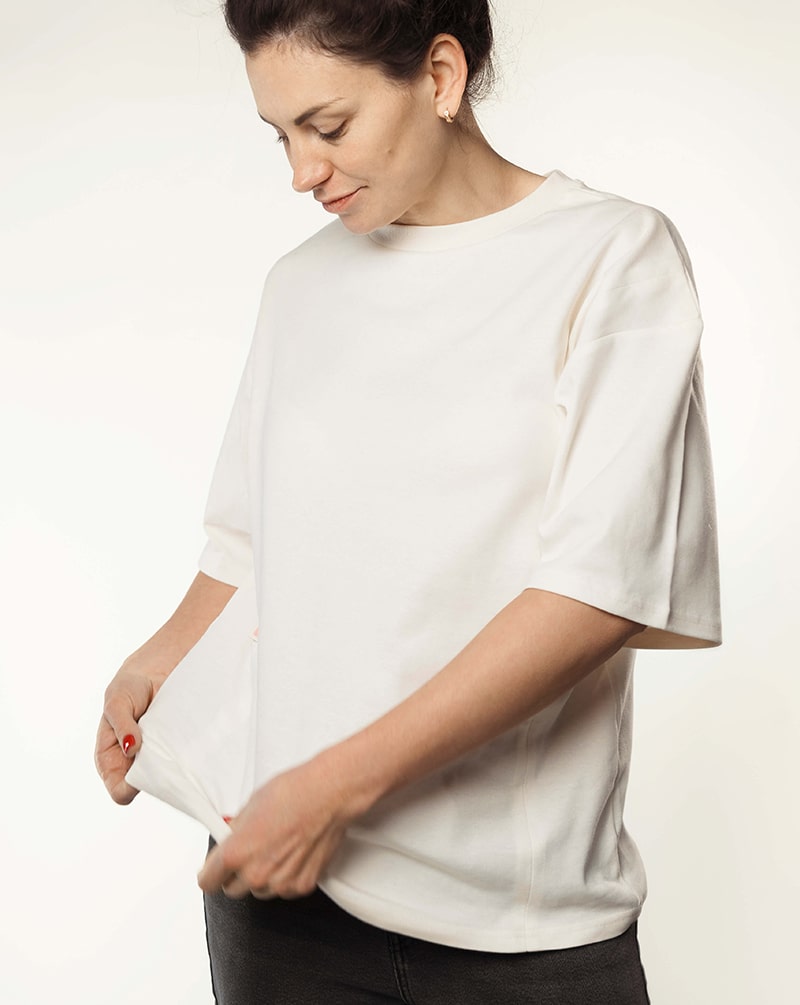 Woman wearing a loose white nursing t-shirt, ideal for breastfeeding fashion.