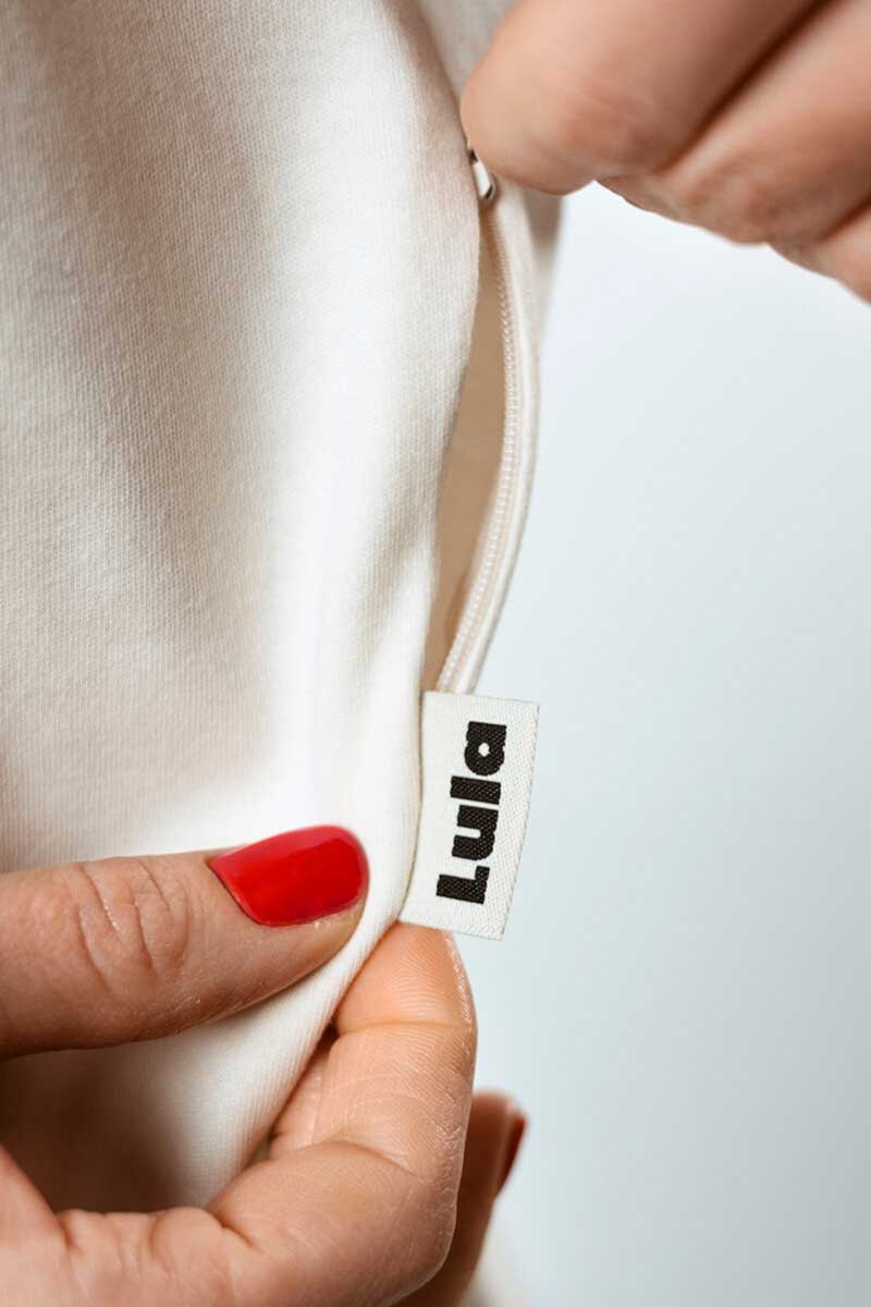 Closeup of a white nursing shirt featuring the high-quality LULA brand label.