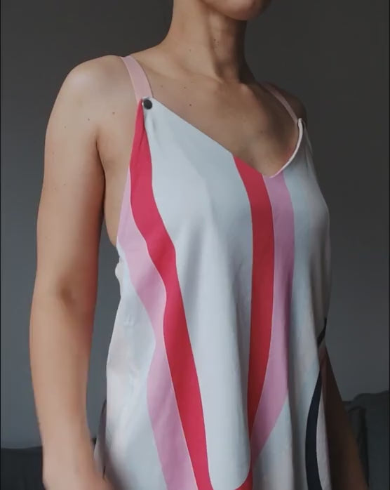 Video of a model demonstrating a colorful nursing top with snap-button fastening for easy breastfeeding access.